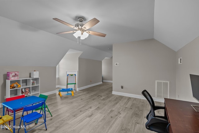 office with light hardwood / wood-style floors, ceiling fan, and vaulted ceiling