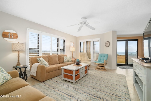 living room with ceiling fan and light tile patterned flooring