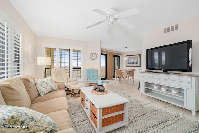 tiled living room featuring ceiling fan