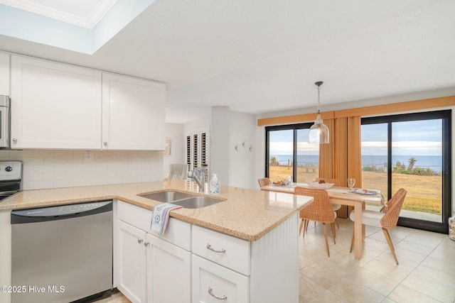 kitchen with stainless steel appliances, white cabinetry, kitchen peninsula, and pendant lighting