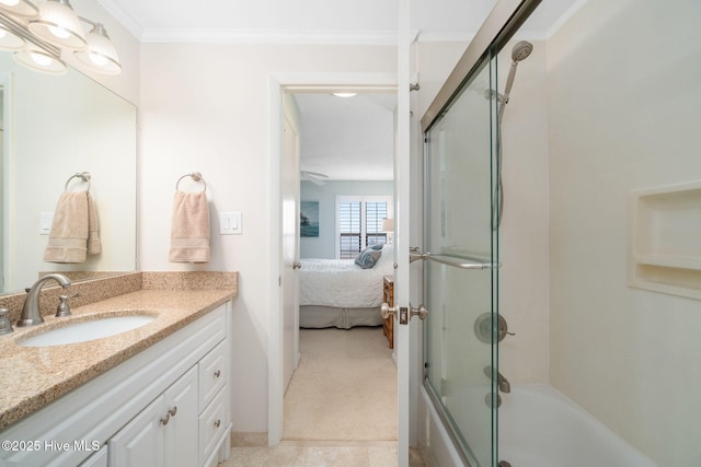 bathroom featuring vanity, bath / shower combo with glass door, and ornamental molding