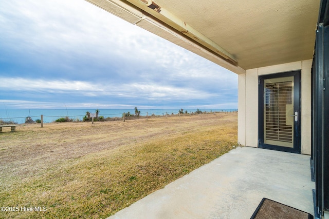 view of yard featuring a patio area and a water view