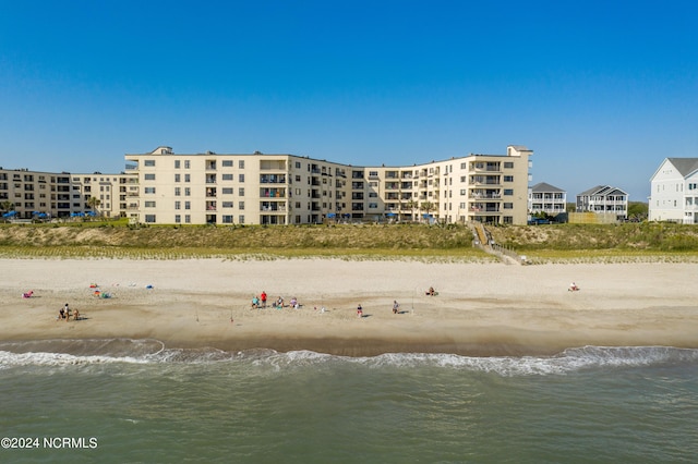 view of property with a view of the beach and a water view