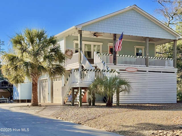 view of front of property featuring ceiling fan, a porch, and a garage