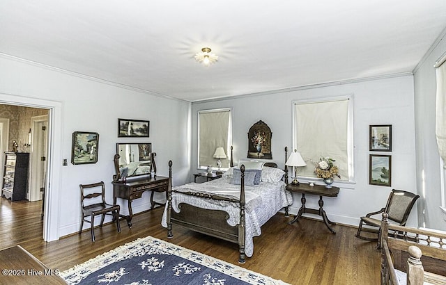 bedroom featuring dark wood-type flooring and crown molding