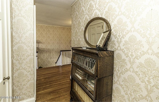 hall featuring dark hardwood / wood-style floors and ornamental molding