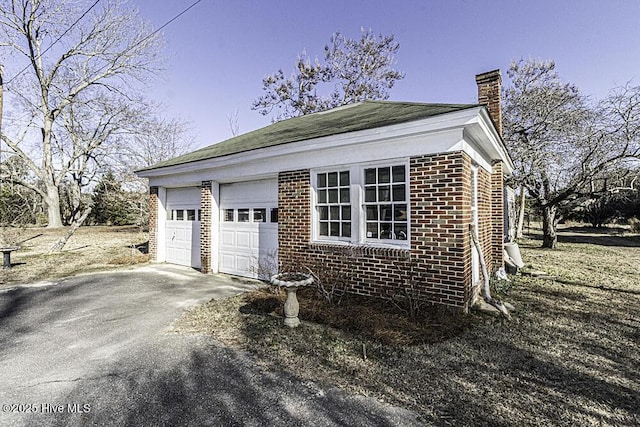 view of home's exterior featuring an outbuilding and a garage