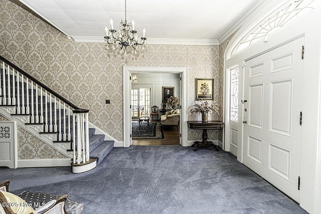 carpeted entryway featuring crown molding and a notable chandelier