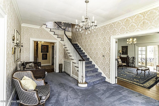 stairs featuring ornamental molding, carpet flooring, and a notable chandelier