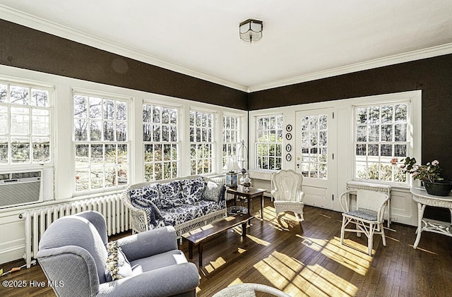 sunroom / solarium with a wealth of natural light, radiator, and cooling unit