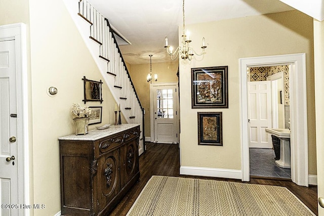 hallway with a chandelier and dark hardwood / wood-style floors