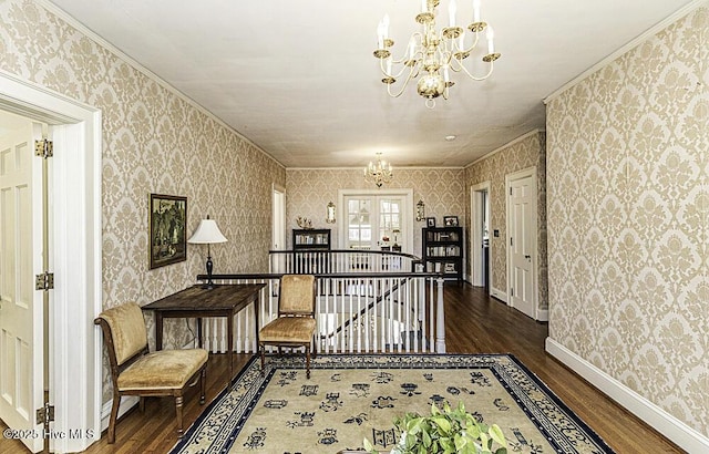 corridor with an inviting chandelier, dark hardwood / wood-style floors, and crown molding