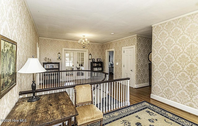 corridor with an inviting chandelier, french doors, dark wood-type flooring, and crown molding