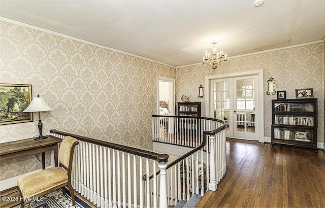 hallway featuring french doors, ornamental molding, dark hardwood / wood-style flooring, and a notable chandelier