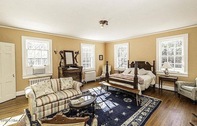 bedroom featuring crown molding, cooling unit, dark hardwood / wood-style flooring, and radiator heating unit