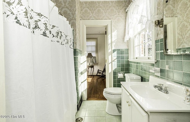 bathroom featuring toilet, vanity, and tile patterned flooring