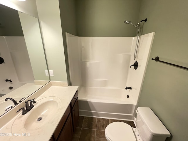 full bathroom featuring shower / washtub combination, vanity, and toilet