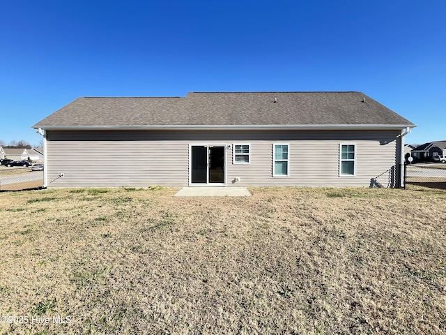 back of house with a lawn and a patio area