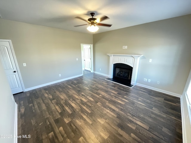 unfurnished living room with dark hardwood / wood-style floors and ceiling fan