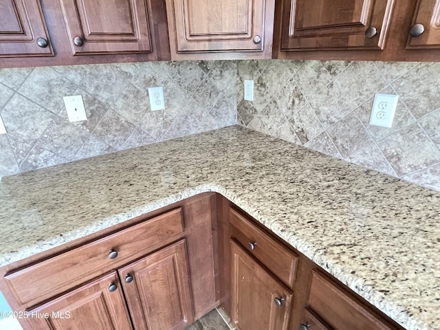 details with decorative backsplash and light stone countertops