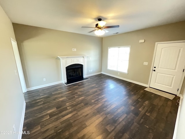 unfurnished living room featuring ceiling fan and dark wood-type flooring