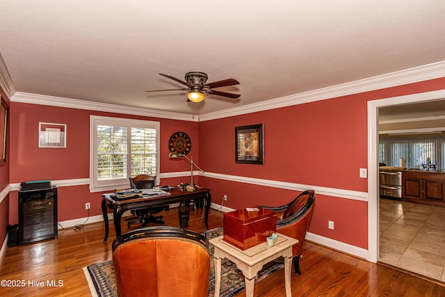 office area with hardwood / wood-style floors, ceiling fan, and ornamental molding