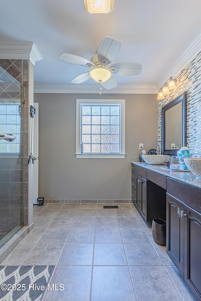 bathroom featuring ceiling fan, an enclosed shower, crown molding, and vanity