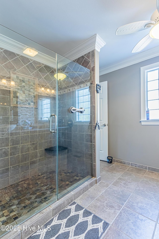 bathroom with crown molding, plenty of natural light, ceiling fan, and walk in shower