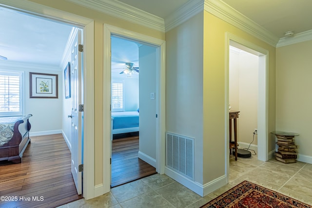 hallway featuring ornamental molding