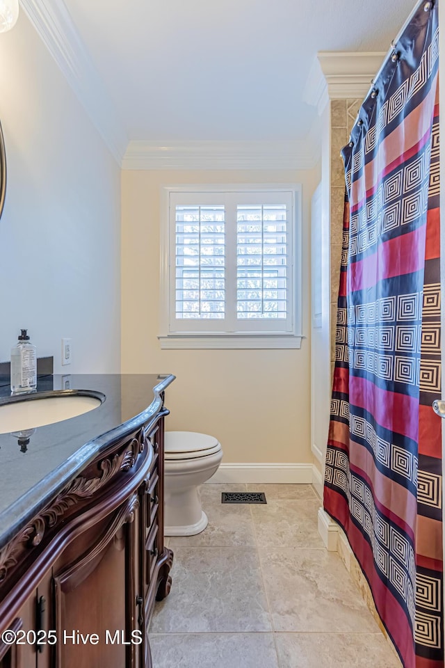 bathroom with vanity, toilet, and ornamental molding