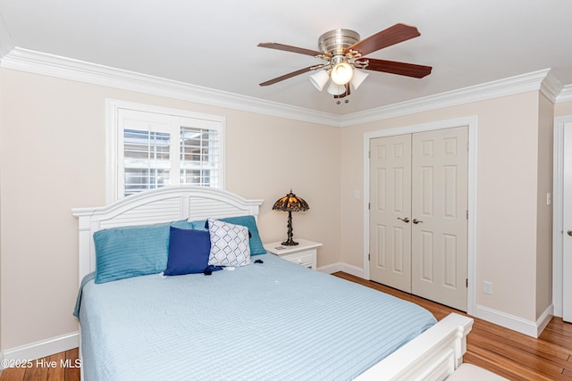 bedroom featuring light wood-type flooring, a closet, ceiling fan, and ornamental molding