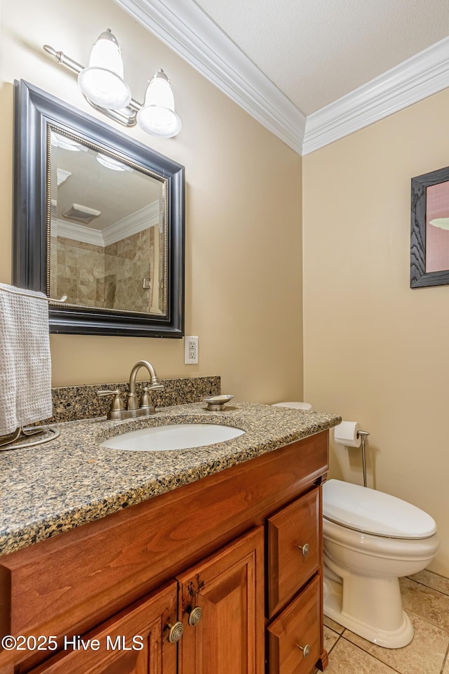 bathroom featuring tile patterned floors, vanity, ornamental molding, and toilet