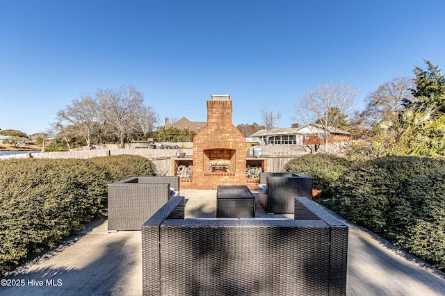 view of patio featuring an outdoor living space with a fireplace