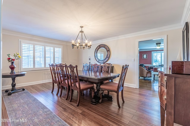 dining space featuring a notable chandelier, wood-type flooring, and crown molding