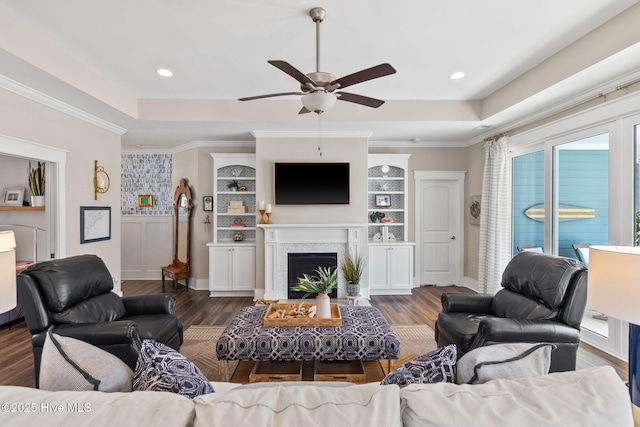 living room featuring crown molding, ceiling fan, dark hardwood / wood-style floors, and a raised ceiling