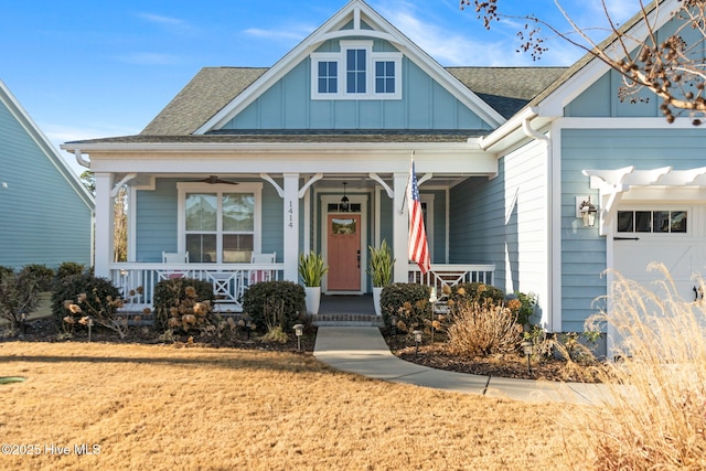 view of front of house featuring a garage, a front lawn, and a porch