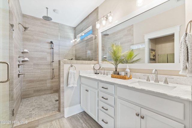 bathroom featuring vanity and an enclosed shower