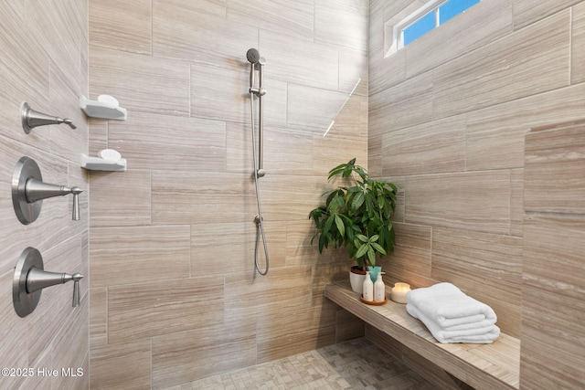 bathroom with tiled shower