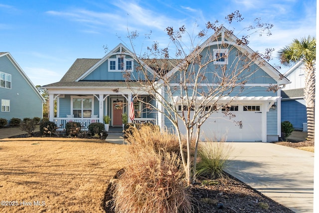 view of front facade featuring a garage, a front lawn, and a porch