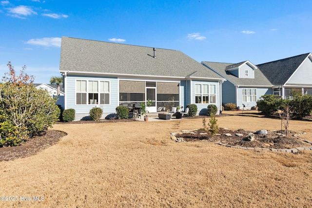 rear view of property with a patio and a yard