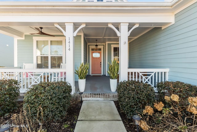 view of exterior entry with a porch and ceiling fan