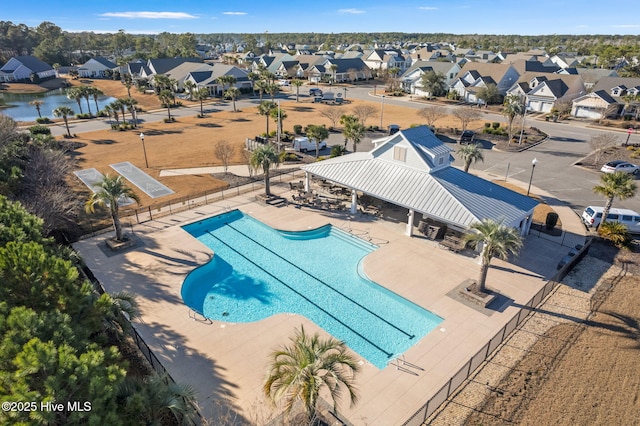 view of pool with a water view and a patio