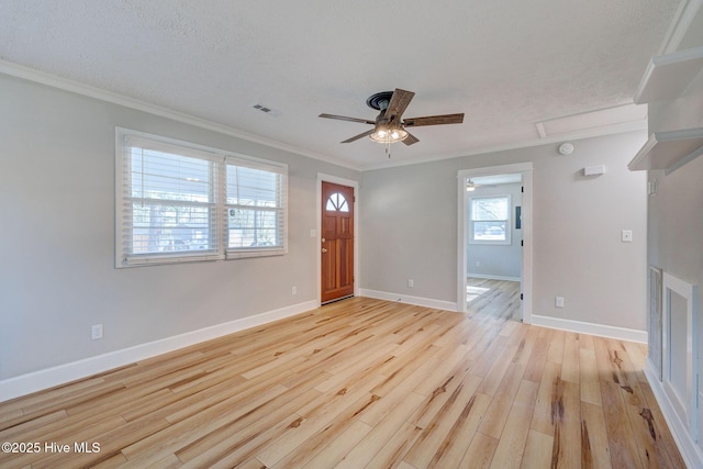 unfurnished living room with ceiling fan, ornamental molding, light hardwood / wood-style floors, and a textured ceiling