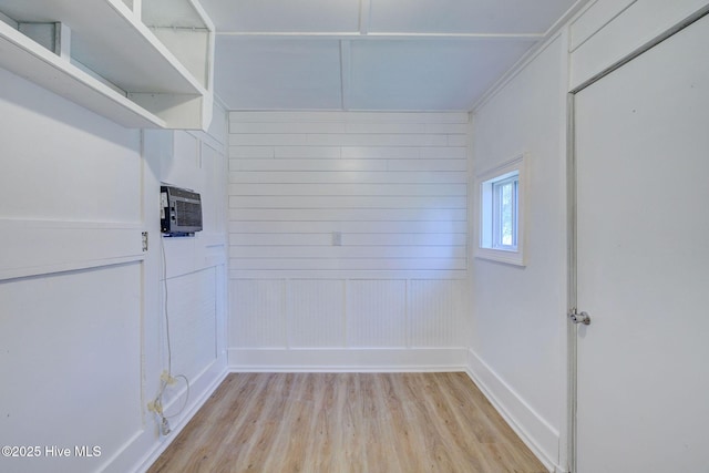 interior space featuring an AC wall unit and light hardwood / wood-style flooring