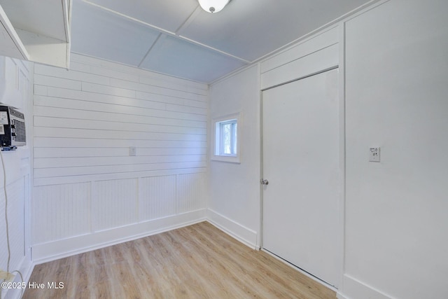 interior space with light wood-type flooring and a closet