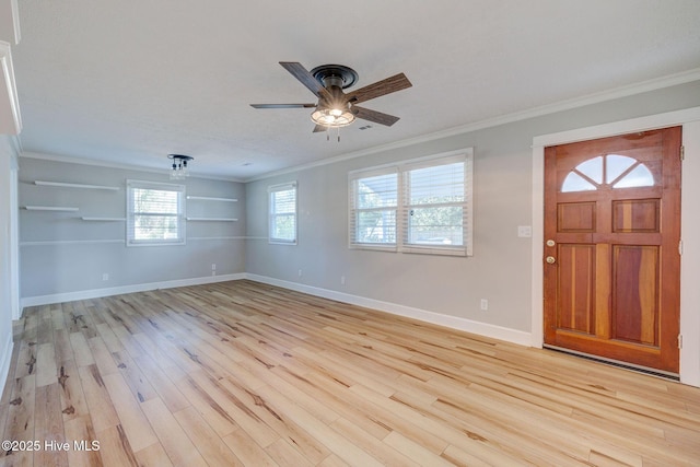 foyer entrance featuring ornamental molding, light hardwood / wood-style floors, and ceiling fan