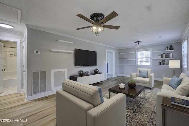 living room featuring ornamental molding, ceiling fan, and light hardwood / wood-style flooring