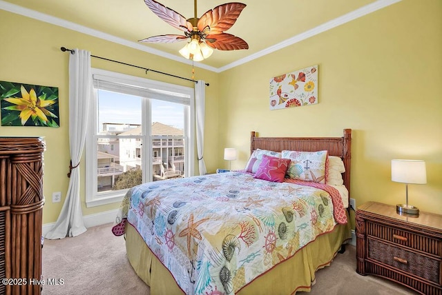 carpeted bedroom featuring ceiling fan and crown molding