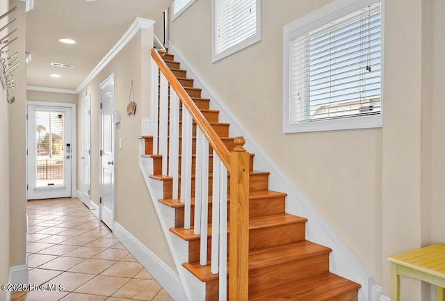 stairs with tile patterned floors and ornamental molding