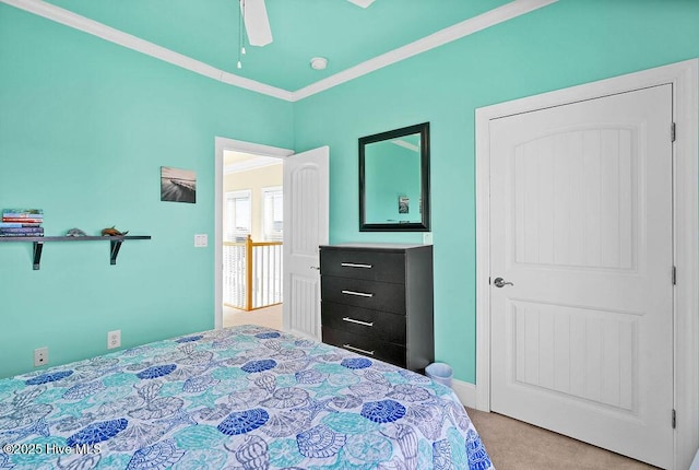 bedroom with ceiling fan, light colored carpet, and ornamental molding